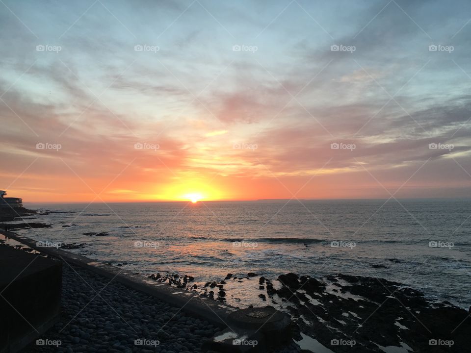 Sunset view over a rustic coastline, Westward Ho! Devon, England. 