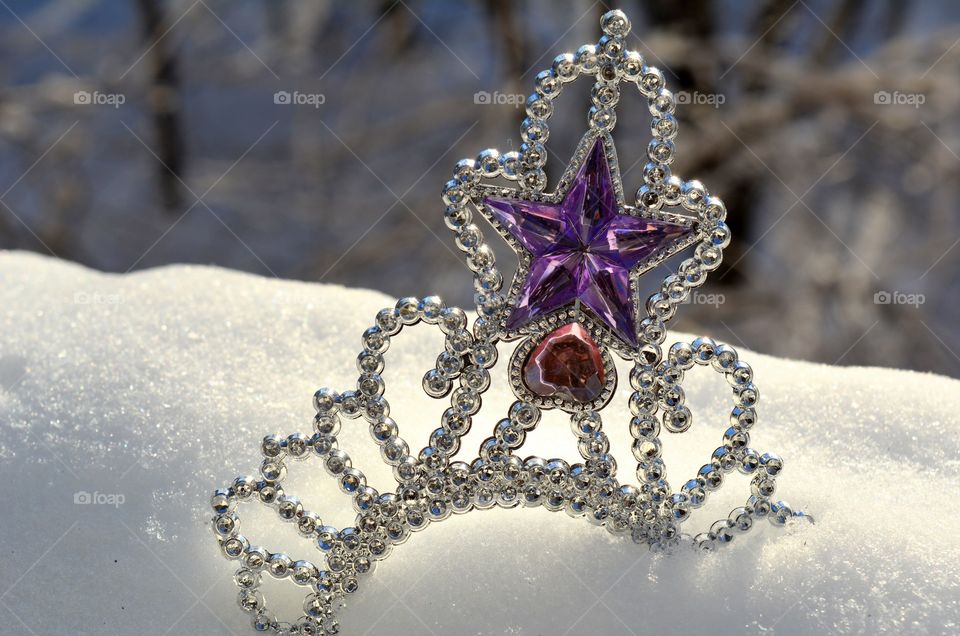 beautiful Christmas silver crown in the snow in the solar light background winter time