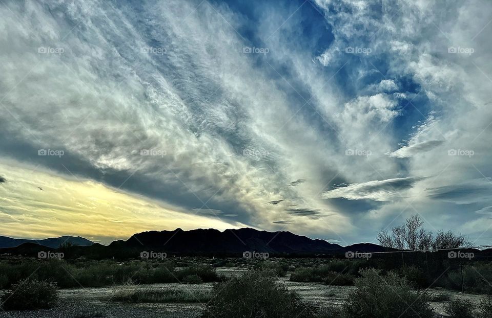 A photo of a cloudy sky with mountains. 