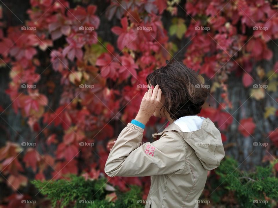 girl on a background of red leaves