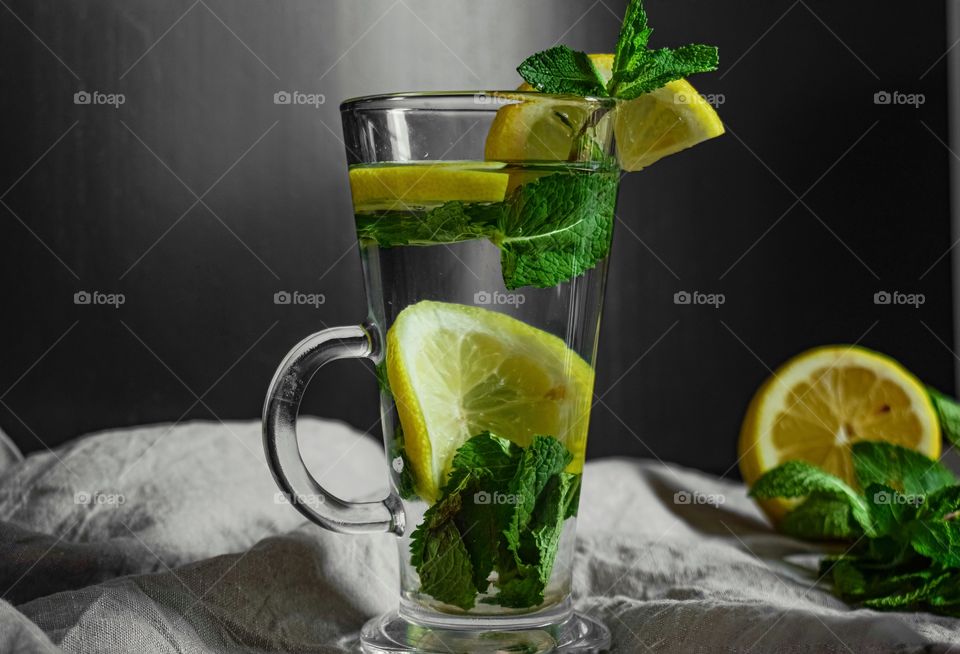 Yellows and green, water with lemon and mint, low key, still life
