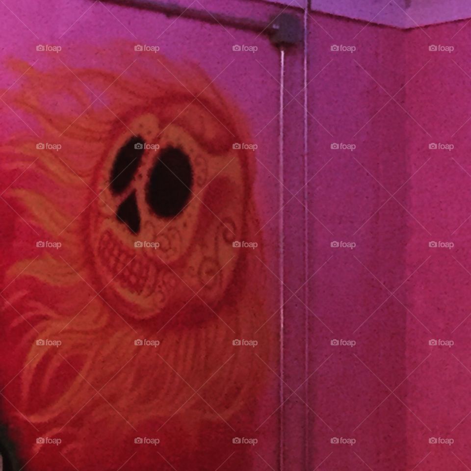 Orange hairy sun mural on pink wall