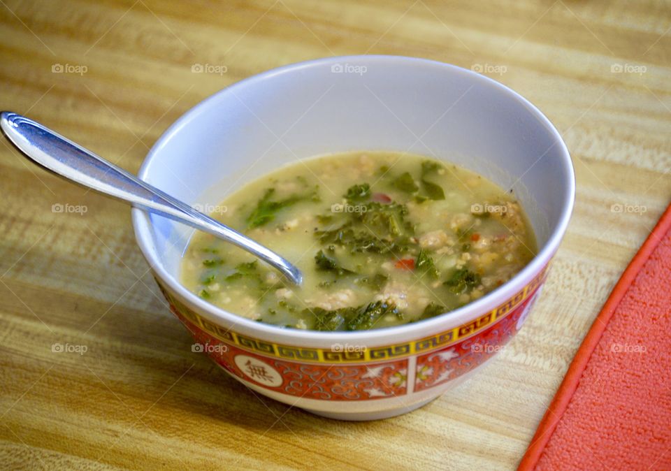 Homemade Toscana soup in a bowl with a spoon 