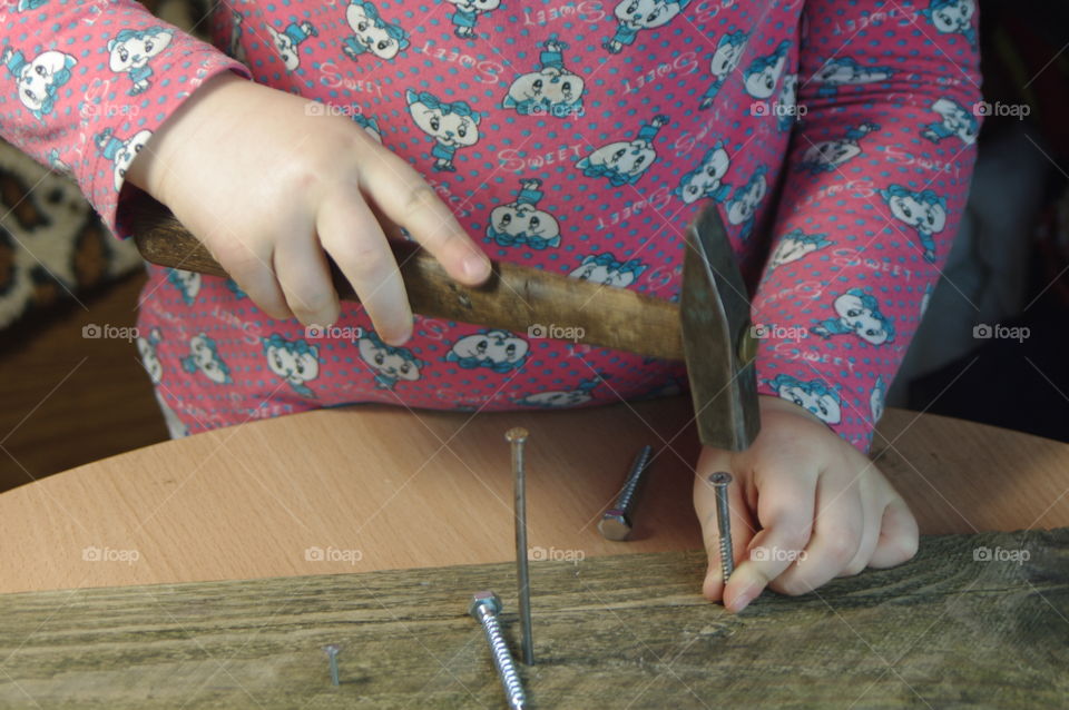 little girl holding tools