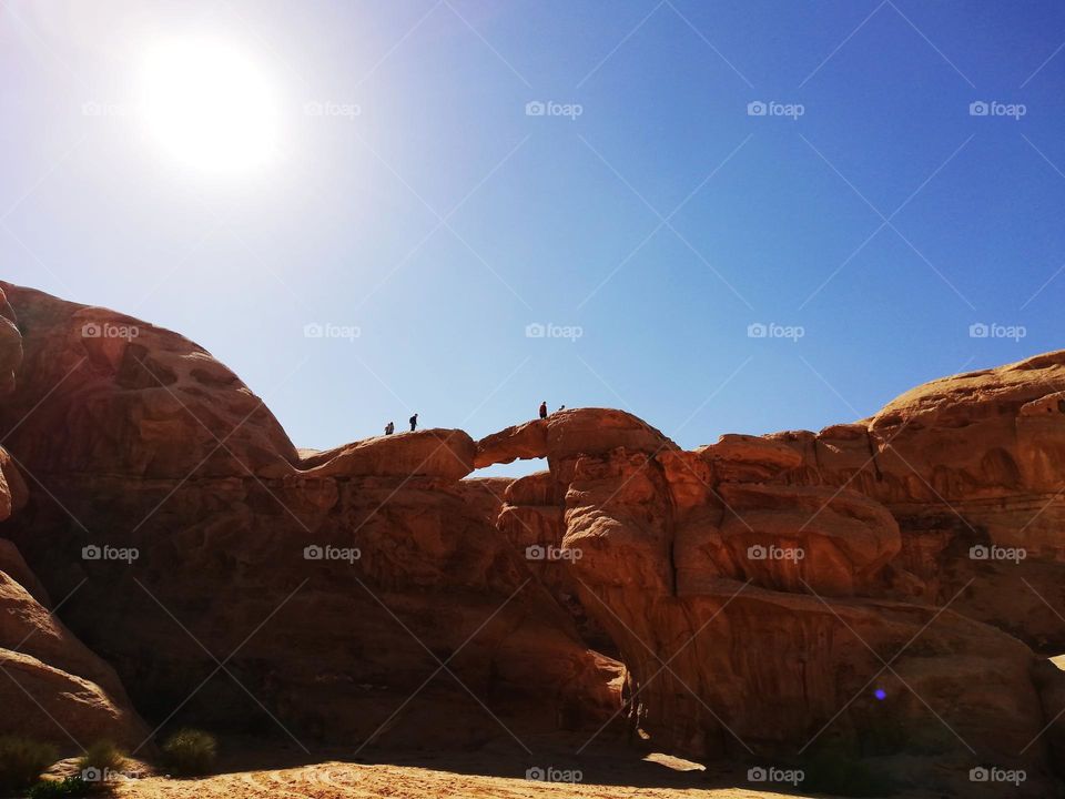 people on the big arch in the Wadi Rum desert in Jordan