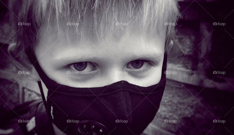 Pollution . My son with his pollution mask on in Beijing 