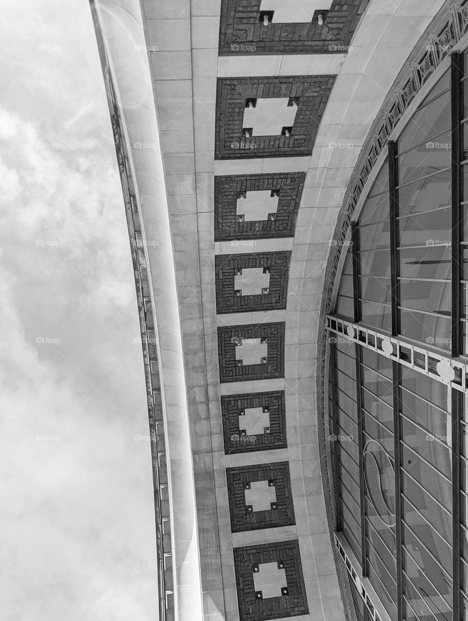 archway with geometric design tiles next to windows in black and white