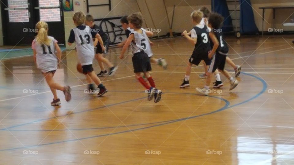 Kids running on the basketball court