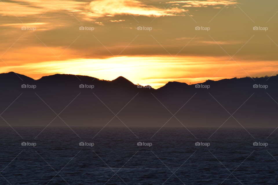 Silhouette of mountain against at dawn