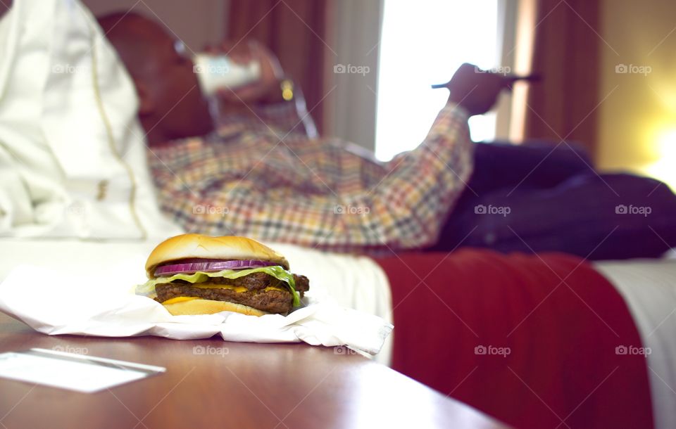 Hotel & Hamburgers. A traveler enjoys a burger. 