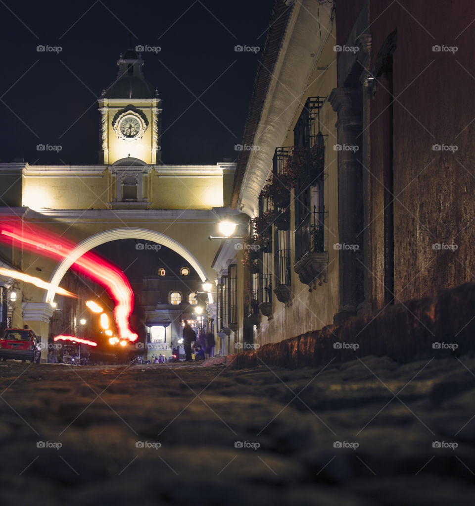 Motorcyle passing through el arco in antigua guatemala