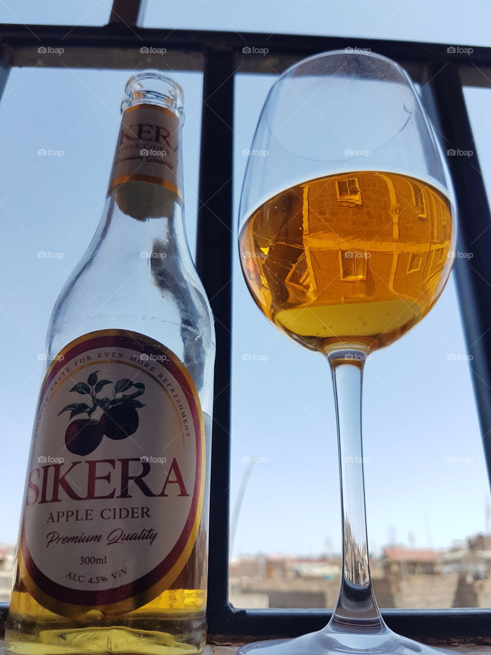 A lady best enjoys a beer in a wine glass and in two servings.