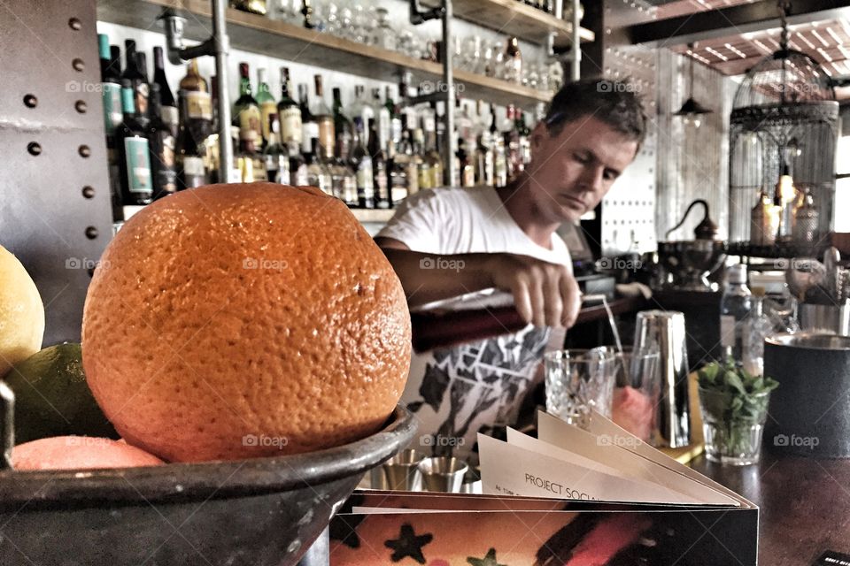 Bartender pouring wine in to the glass