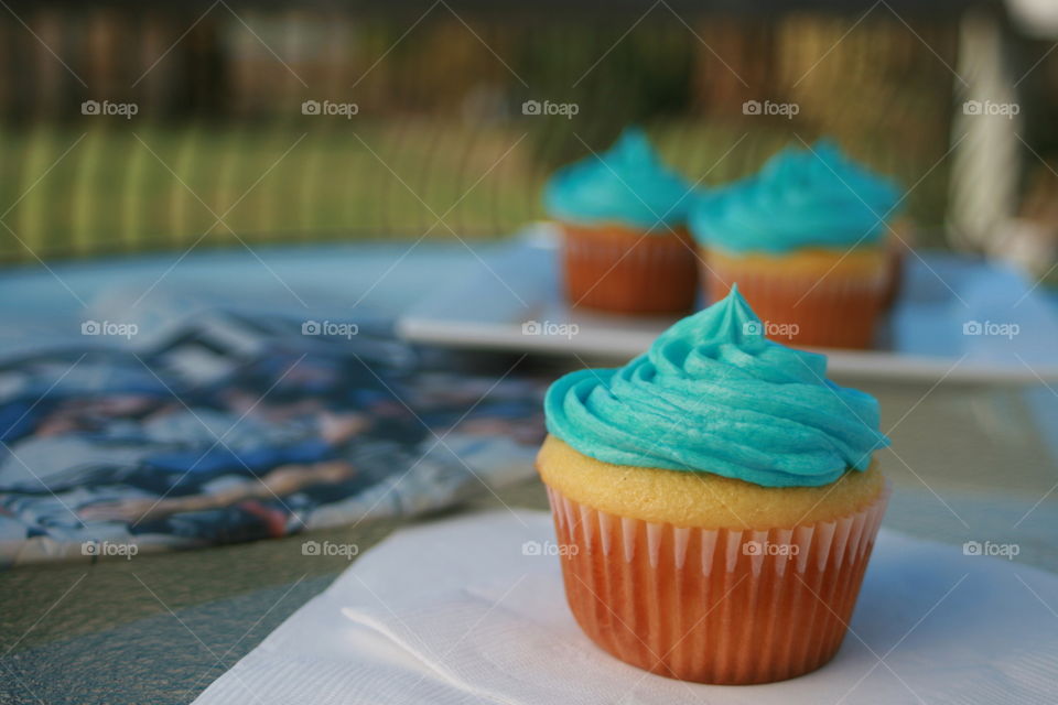 Cupcake with turquoise whipped cream
