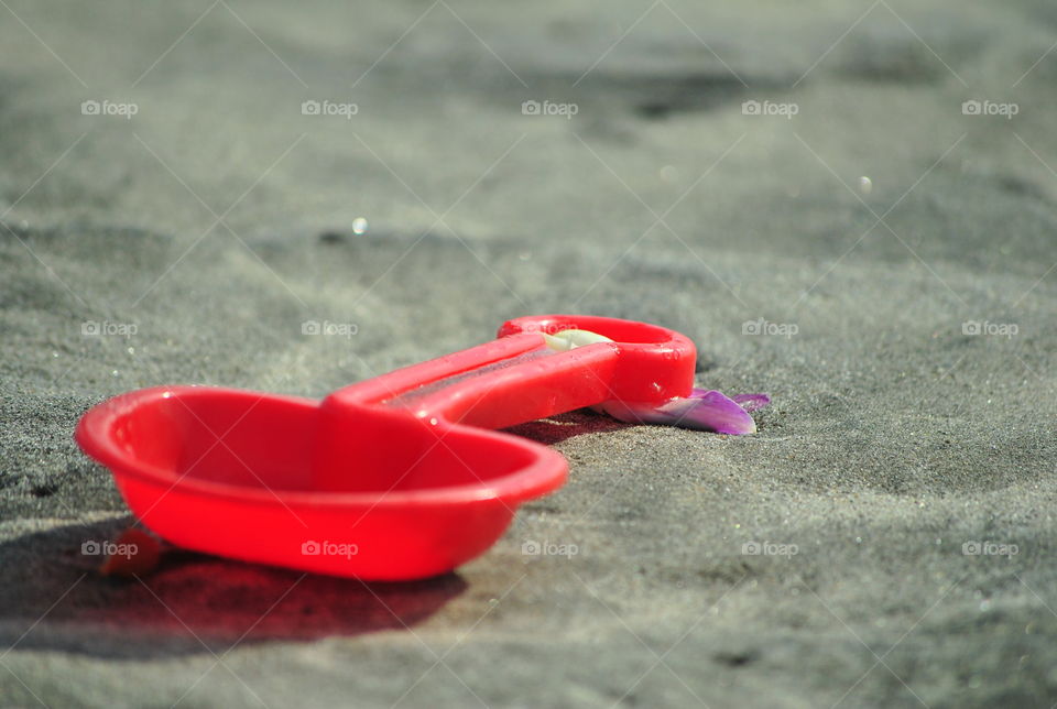 Toy shovel in sand