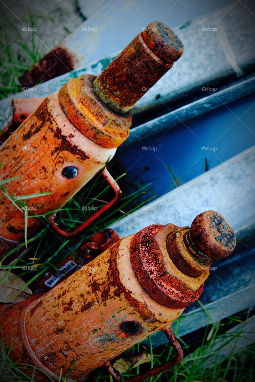 Rusty Jacks leaning up against a garden shed.