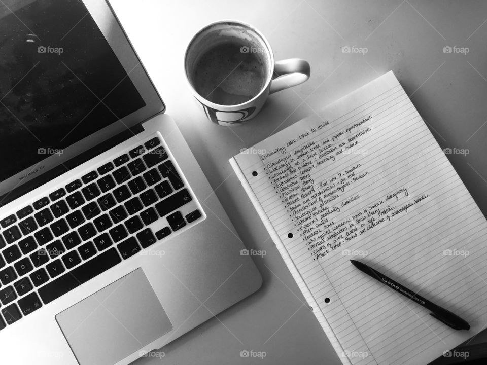 Elevated view of laptop with notebook and coffee cup
