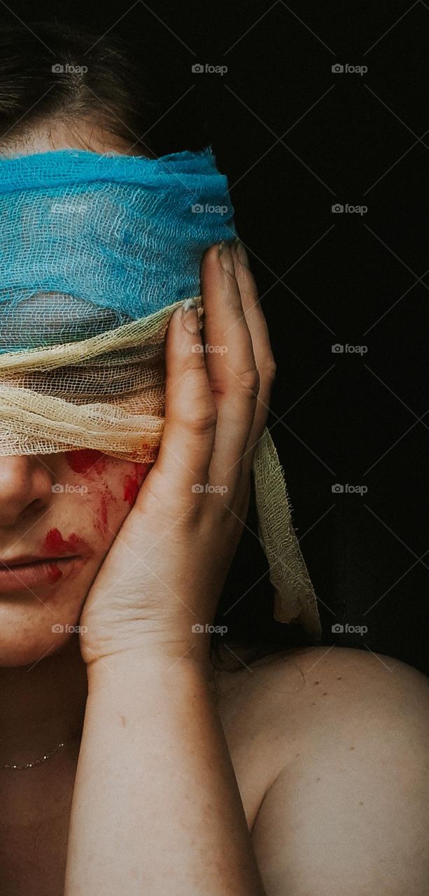 A portrait of a girl with bandages instead of eyes, which shows the struggle of the Ukrainian people for independence