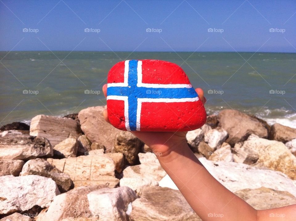 Flag Norway on a stone with sea background