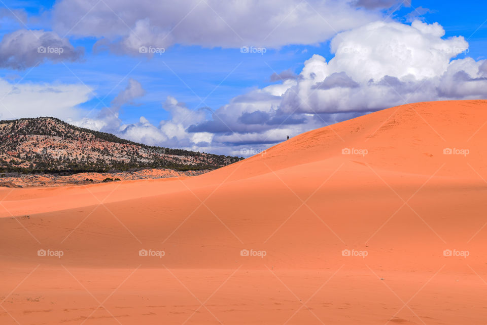 Sand dunes, mountains and clouds in the sky