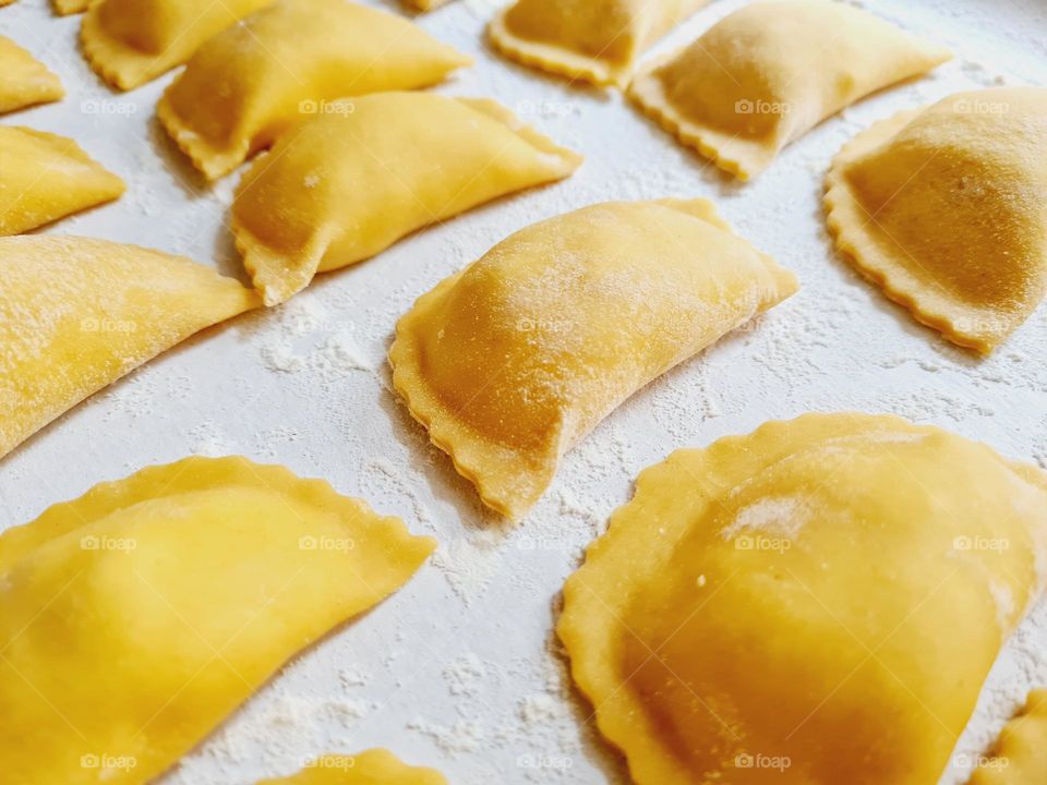 Handmade ravioli on the tray ready to be cooked