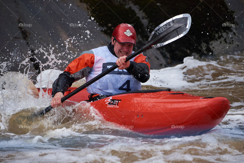 Helsinki, Finland - April 15, 2018: Unidentified racer at the annual Icebreak 2018 whitewater kayaking competition at the Vanhankaupunginkoski rapids in Helsinki, Finland.