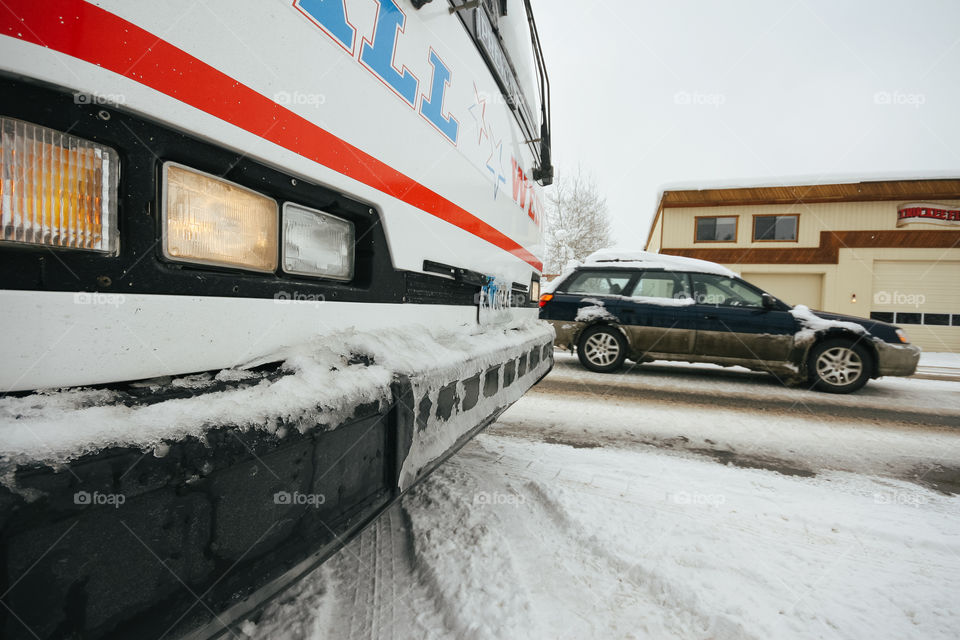 Snow slush on the road with cars and bus 