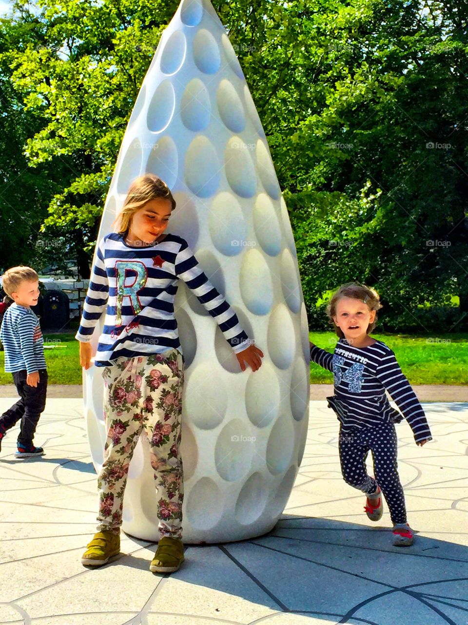 Brother and sister playing in park