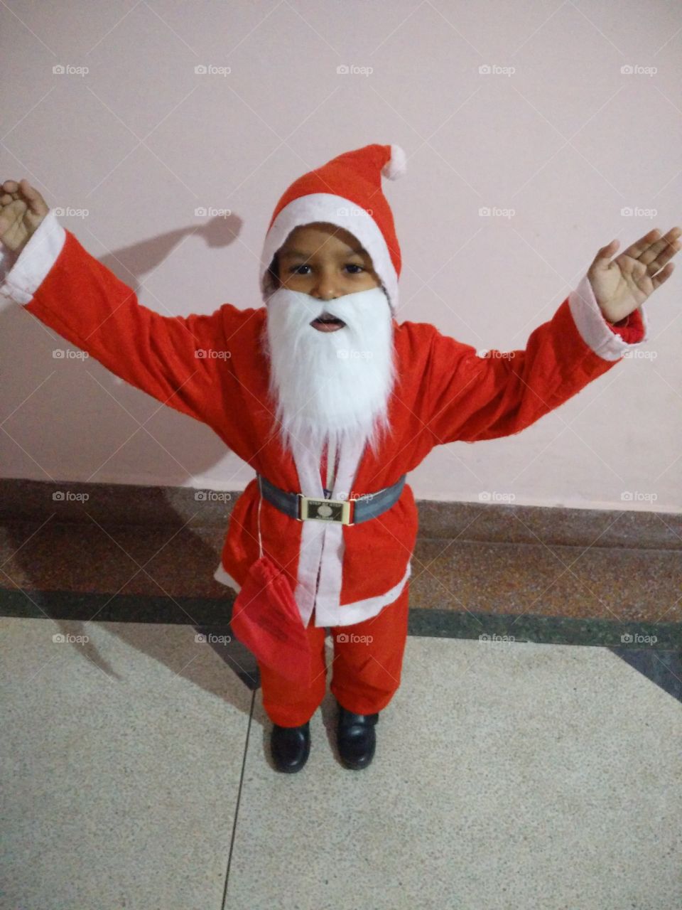 Close-up of boy in Santa Claus costume