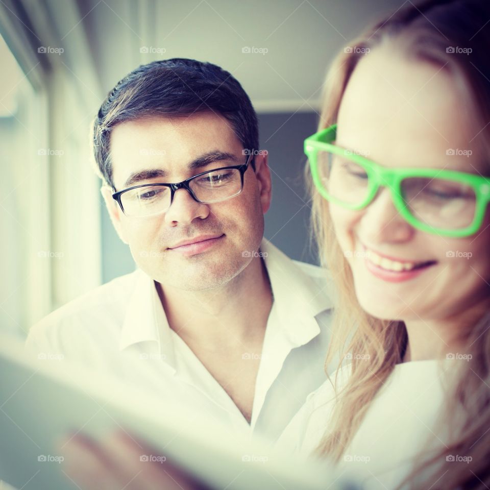 People business . a man and woman looking at a tablet