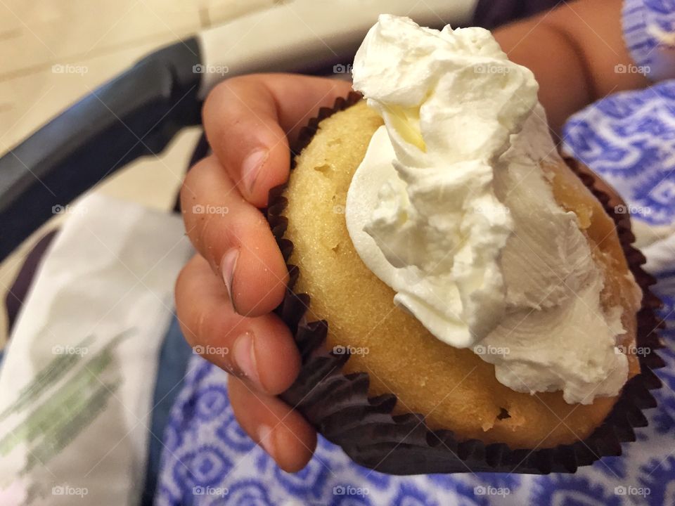 Toddler enjoying cupcake