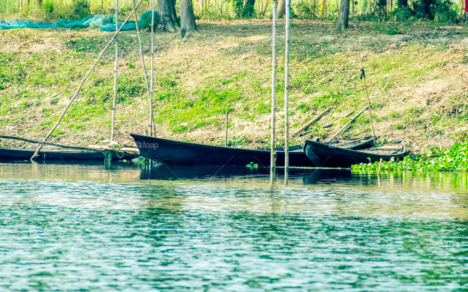 Bird watching rowing boats on the shore of wetland of Chupir Chor oxbow lake (Damodar and Ganges river with tropical lush of Gangetic plains) in Purbasthali Birdwatching place, West Bengal India.