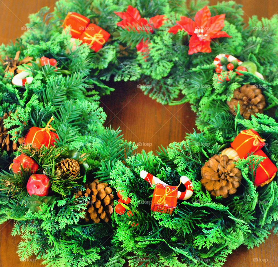 green and red christmas wreath on wooden table, decor, ornament