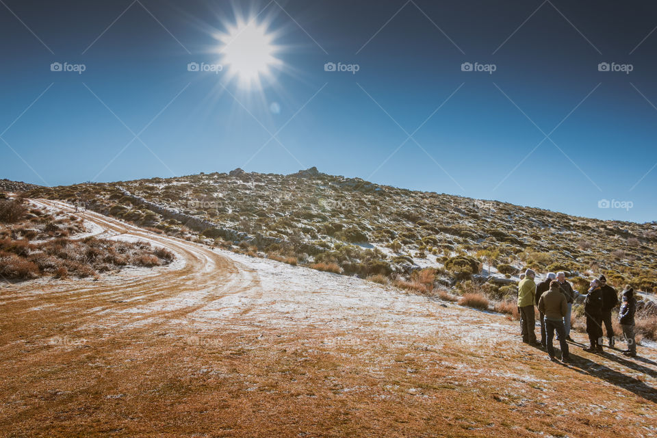 People walkin across countryside 