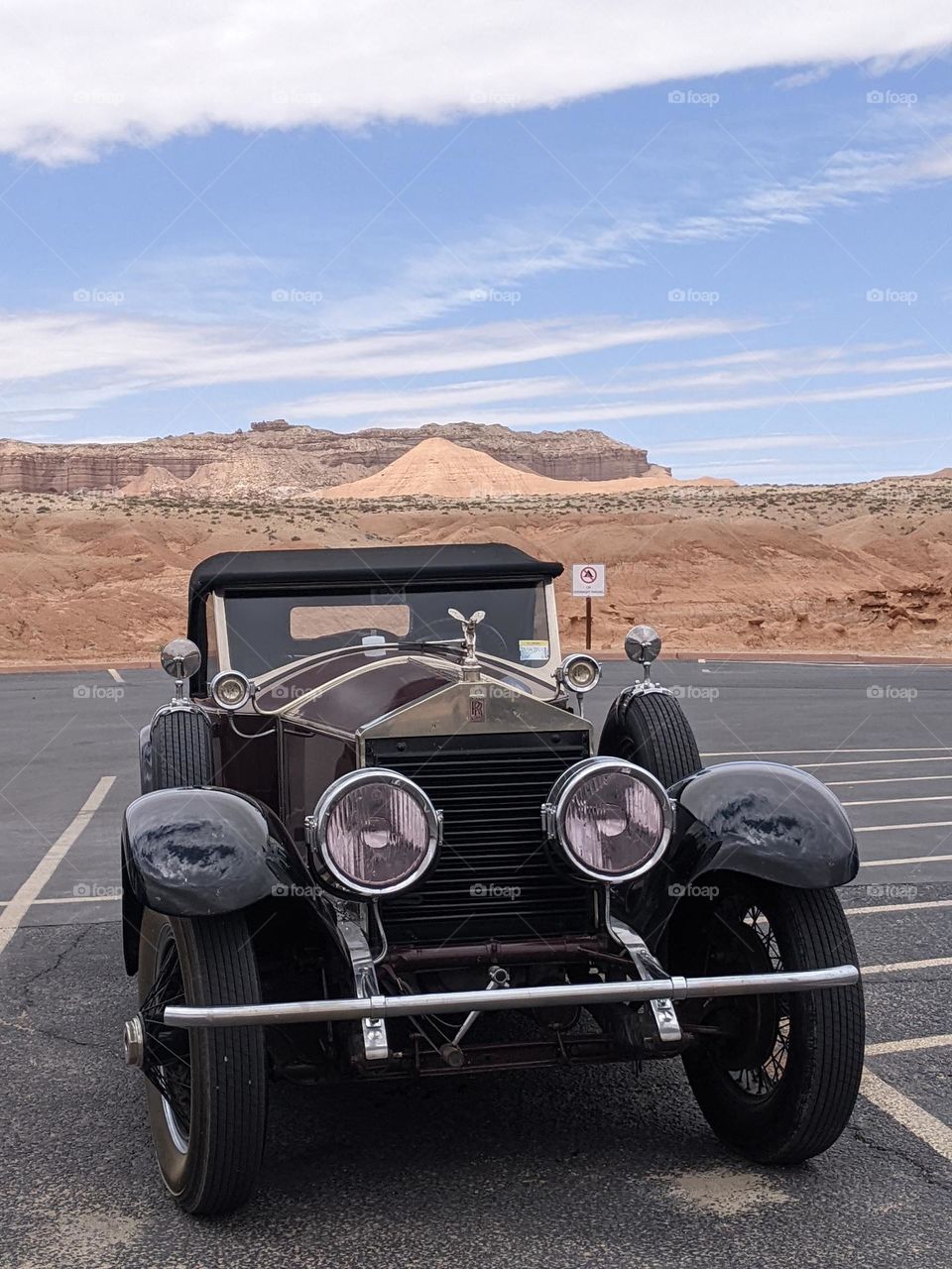 Rolls royce in front of a dessert mountain