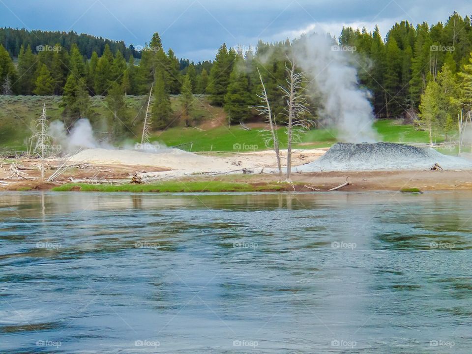Steaming geyser across the river