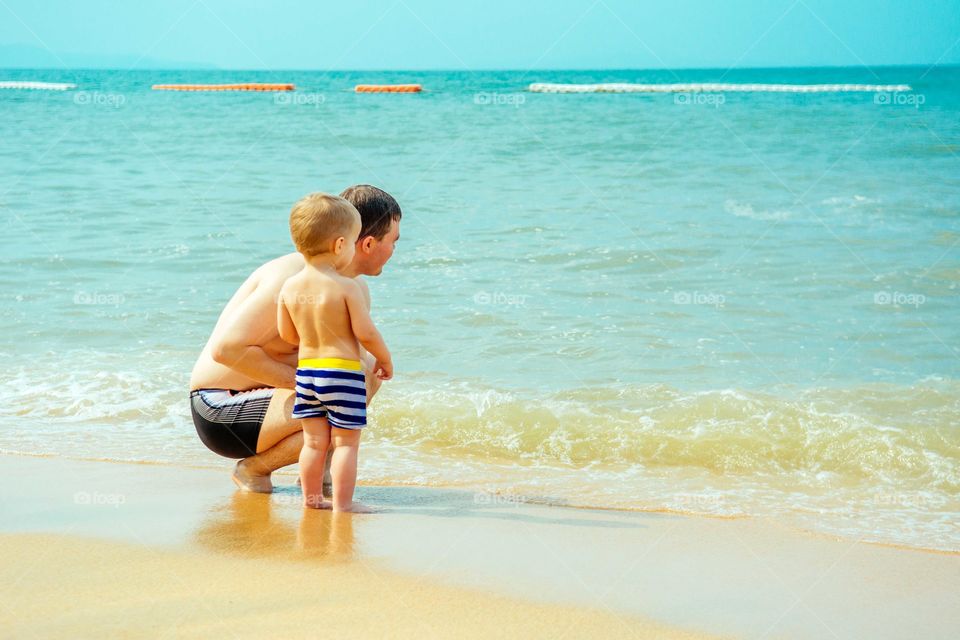 Father and son enjoying at beach