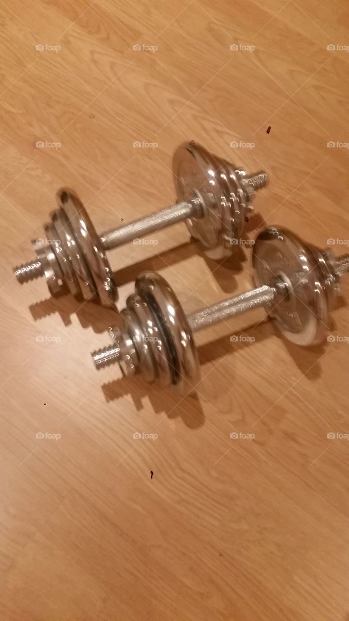 Dumbells on a wooden floor