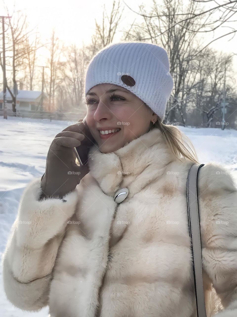 portrait of a girl in the winter on the street speaks on the phone