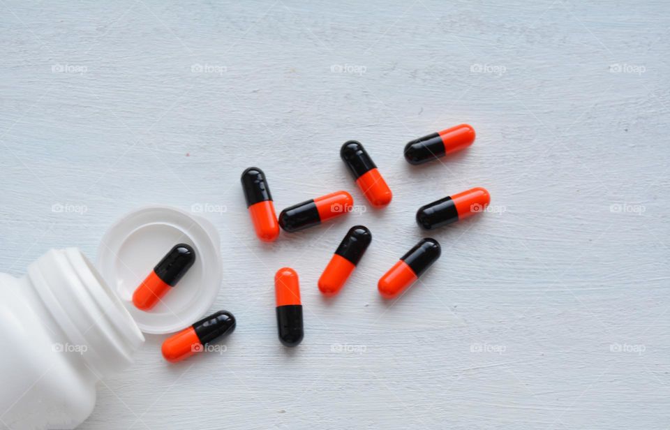 vitamins capsules colour on a white background