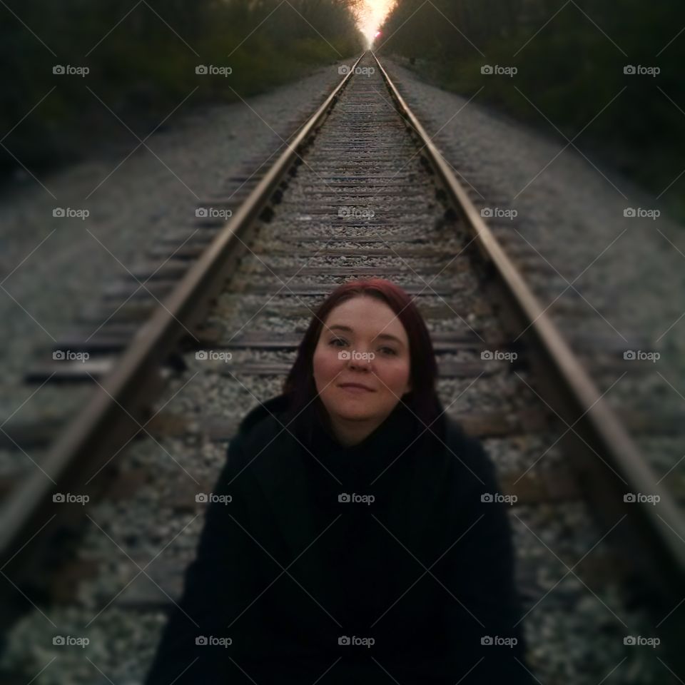 Woman standing on railway track