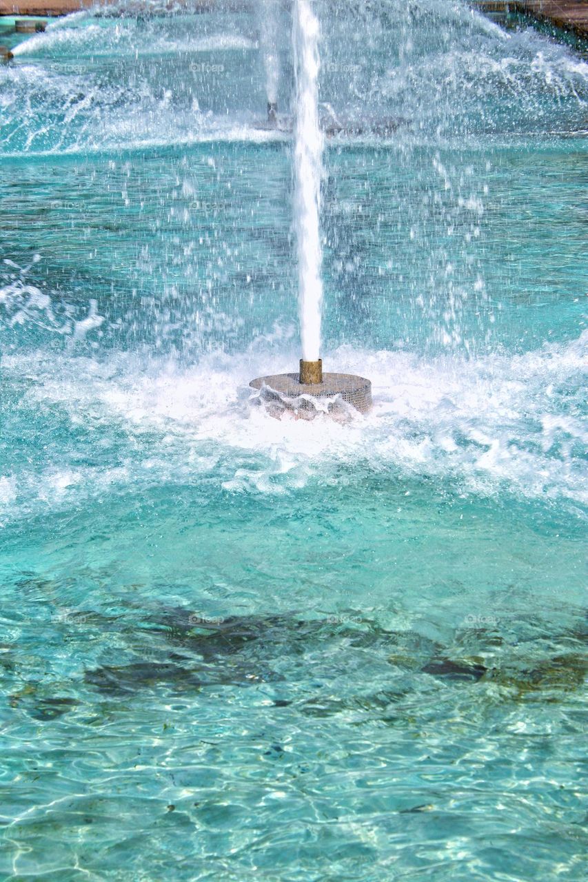 Close up of turquoise colored bubbling water of a fountain