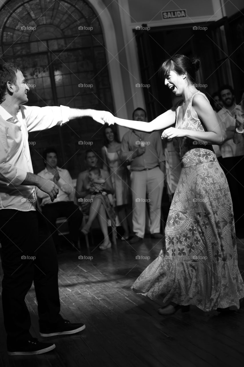 Happy couple dances in a party