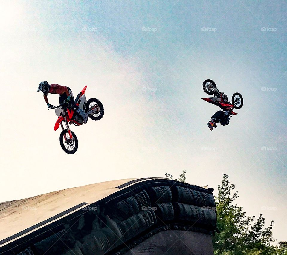 Motocross bikers fly into the sky in spectacular fashion 