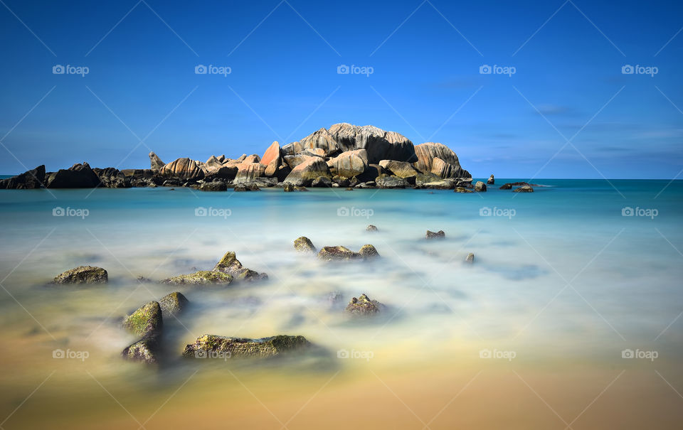Long exposure seascape with blue sky background