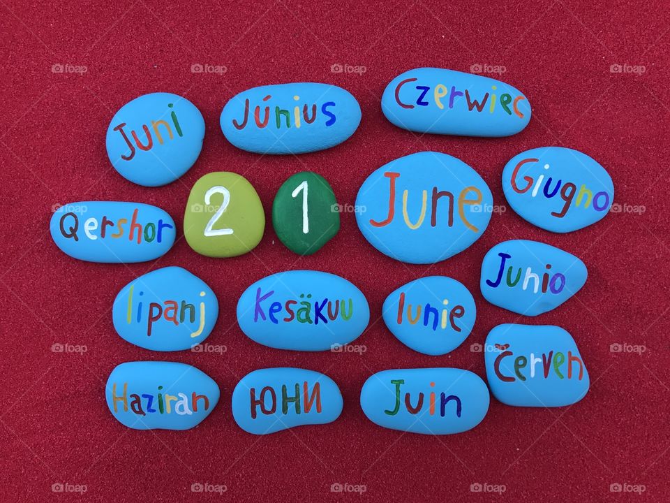 21 June, calendar date in many languages with colored stones and red background 