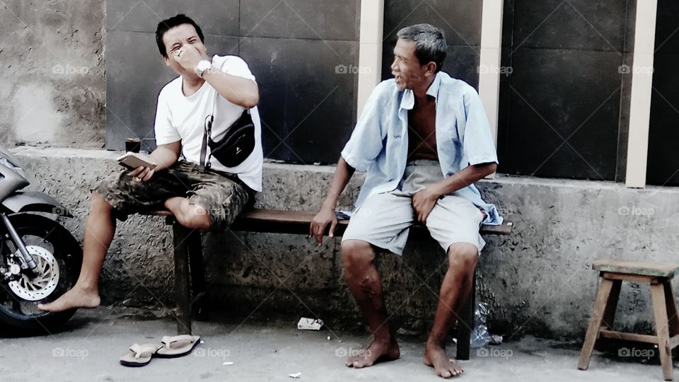 Two man sitting on bench