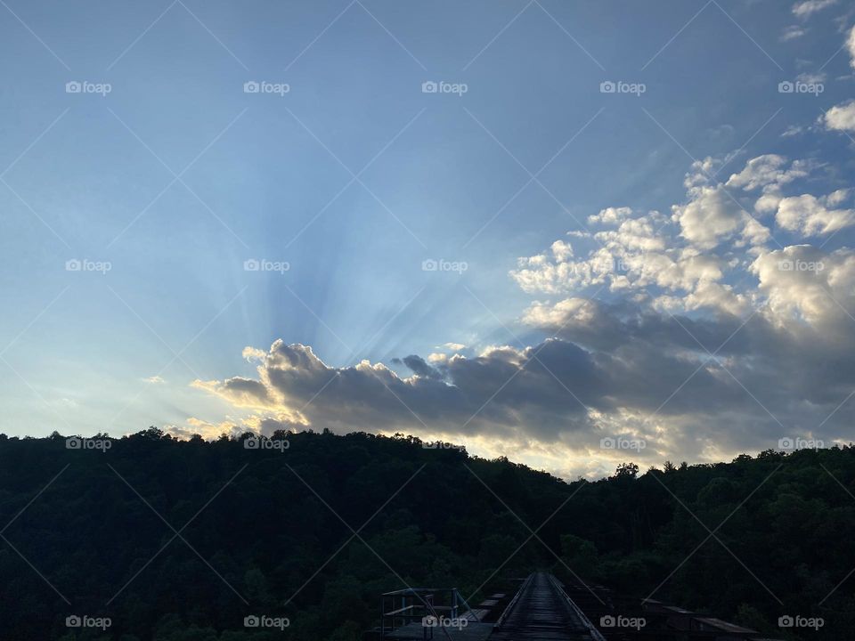 Rays of light shining through the clouds.