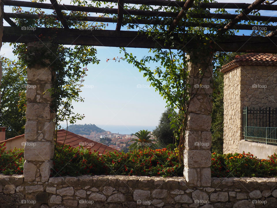 View of city of Nice from the stone pergola in the monastery gardens in Cimiez, France.