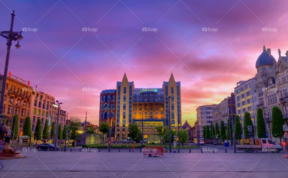 Queen Astrid place, Antwerp, Belgium in March 2019. Dramatic and colorful sunrise sky over the hotel and queen Astrid place